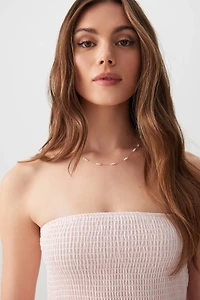 Robe courte sans bretelles nouée au dos