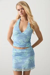 Jupe courte en maille filet doublé fleuri