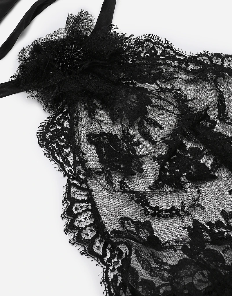 Asymmetrical lace top with flower detail on neck