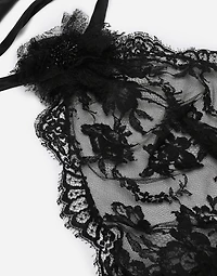 Asymmetrical lace top with flower detail on neck