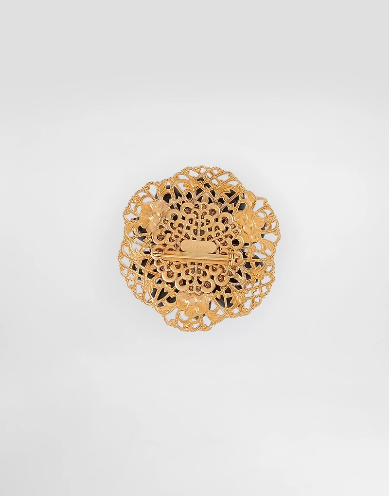 Metal brooch with rhinestones
