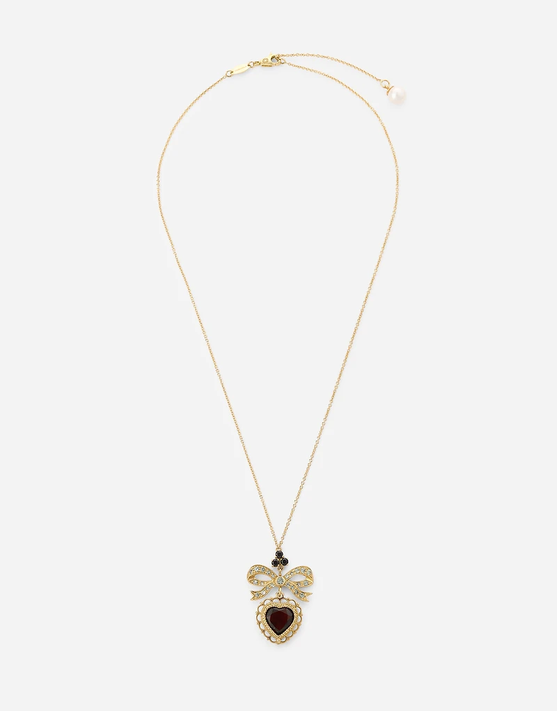 Devotion Pendant
18 carat yellow gold, red garnet and gray sapphires