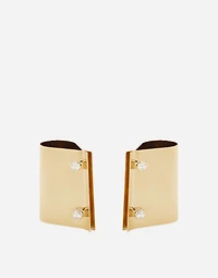 Rigid metal cuffs and rhinestone-detailed buttons