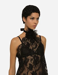 Asymmetrical lace top with flower detail on neck