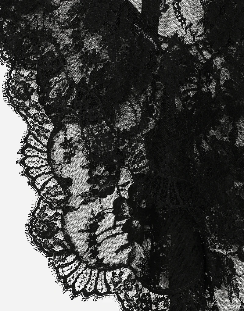 Asymmetrical lace top with flower detail on neck