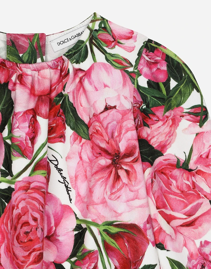 Interlock dress with rose print over a white background
