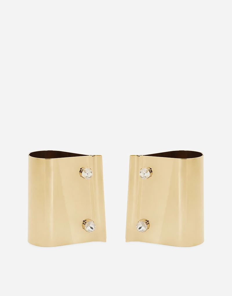 Rigid metal cuffs and rhinestone-detailed buttons