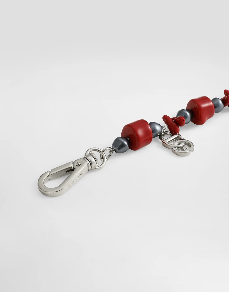 Metal bracelet with coral details and logo