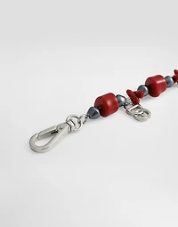 Metal bracelet with coral details and logo