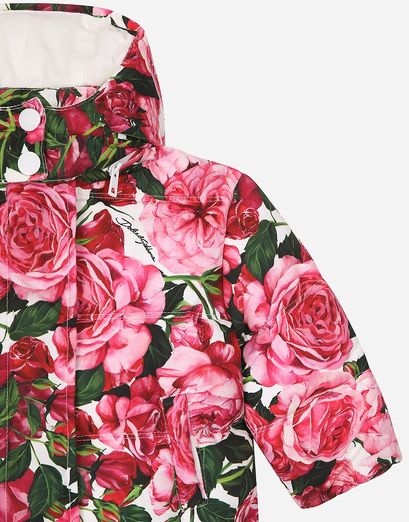 Short nylon down jacket with rose print over a white background