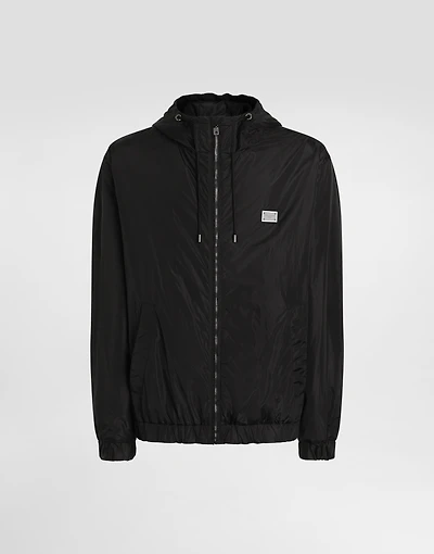 Technical fabric jacket with hood and tag