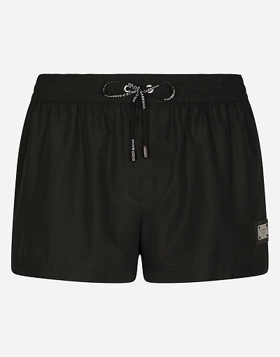 Short swim trunks with branded tag