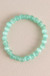 Pastel Green Cat's Eye Beaded Bracelet is a shimmering shining two toned accent piece that would upgrade any whimsical outfit