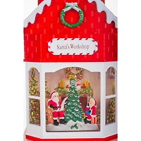 Boule à neige suspendu en plastique rouge atelier du Père Noël avec DEL et paillettes