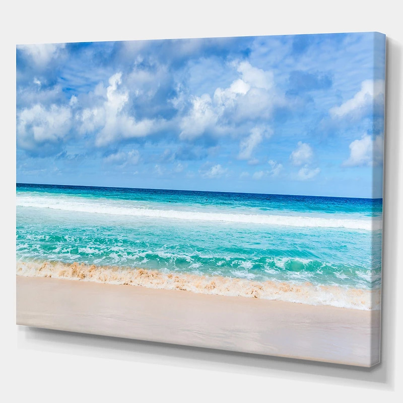 Tranquil Beach Under White Clouds  Canvas Artwork
