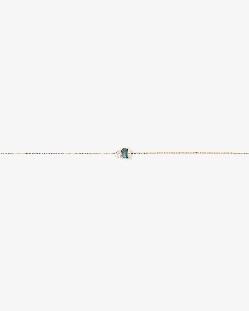 Bracelet avec saphir blanc taille poire et topaze bleu de Londres taille émeraude en or jaune 10 carats