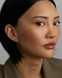 Oval Cut Blue Aquamarine Gemstone and 0.27 Carat TW Diamond Halo Stud Earrings in 10kt White Gold