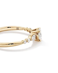 0.59 Carat TW Oval and Pear Sidestone Engagement Ring in 14kt Yellow Gold