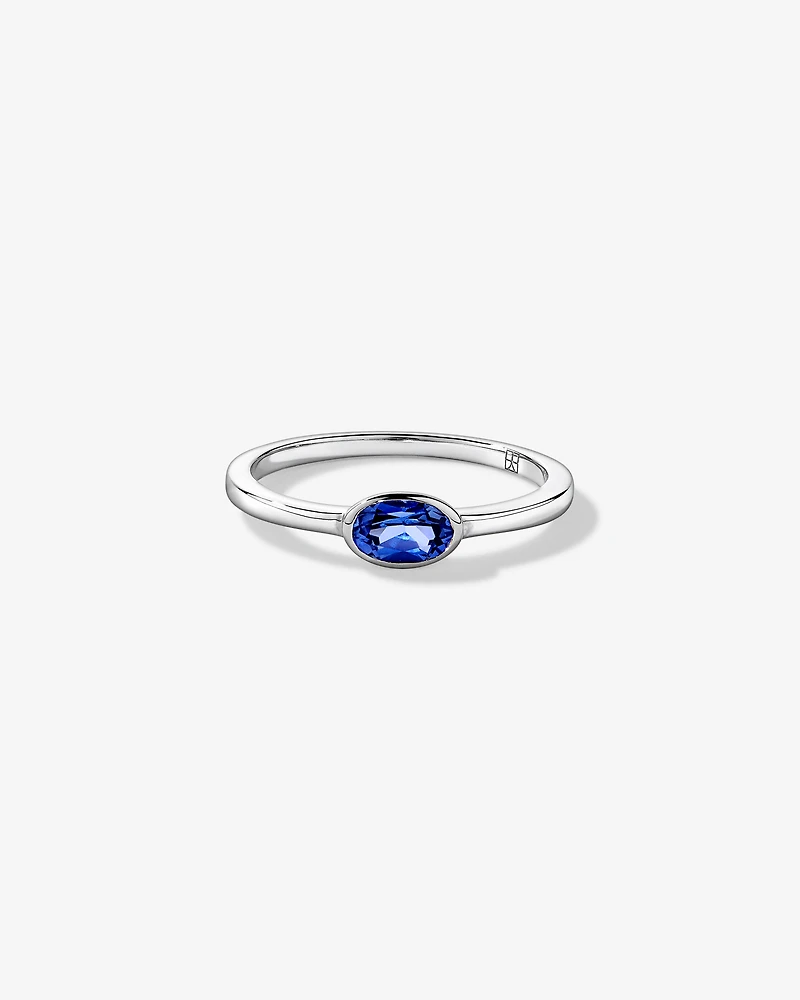 Oval Blue Created Sapphire East-to-West Set Bezel Ring 10kt Gold