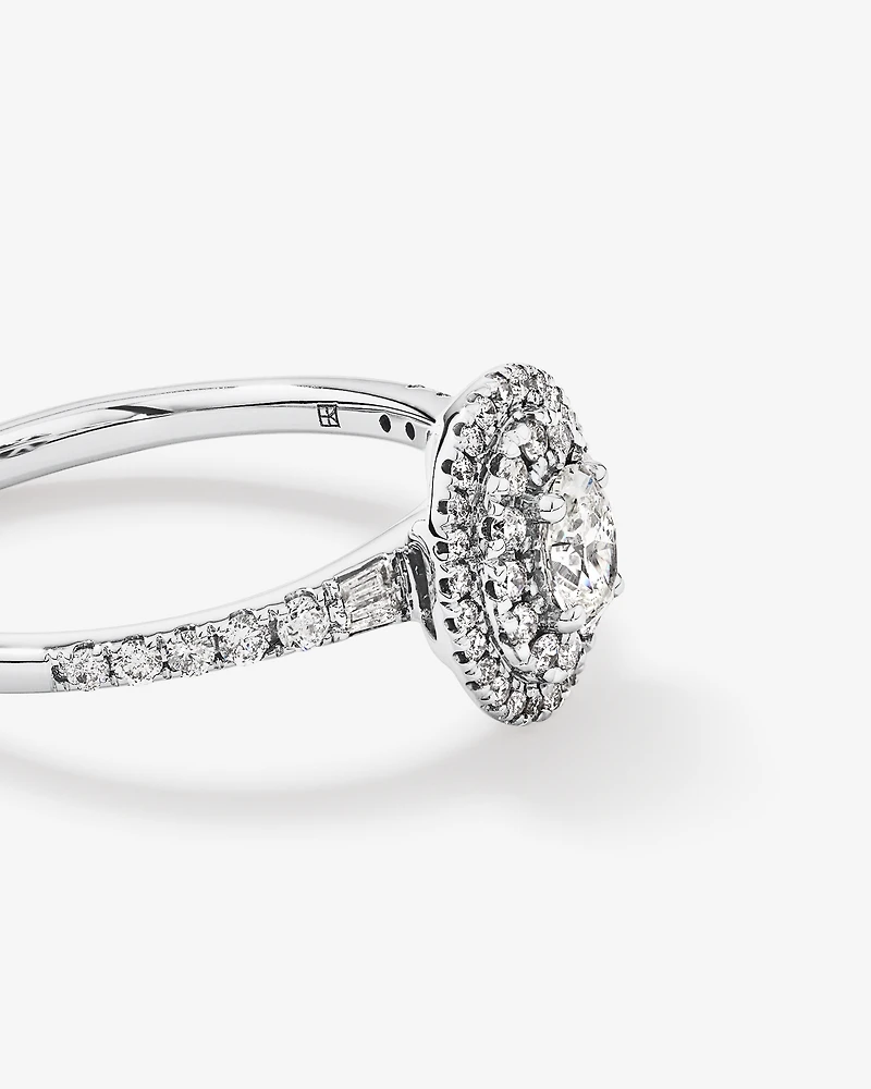 0.58 Carat TW Oval Diamond Halo Baguette Side Accent Engagement Ring in 14kt White Gold