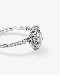 0.58 Carat TW Oval Diamond Halo Baguette Side Accent Engagement Ring in 14kt White Gold