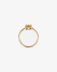 Bague en or jaune 10 carats avec citrine taille émeraude et halo de diamants