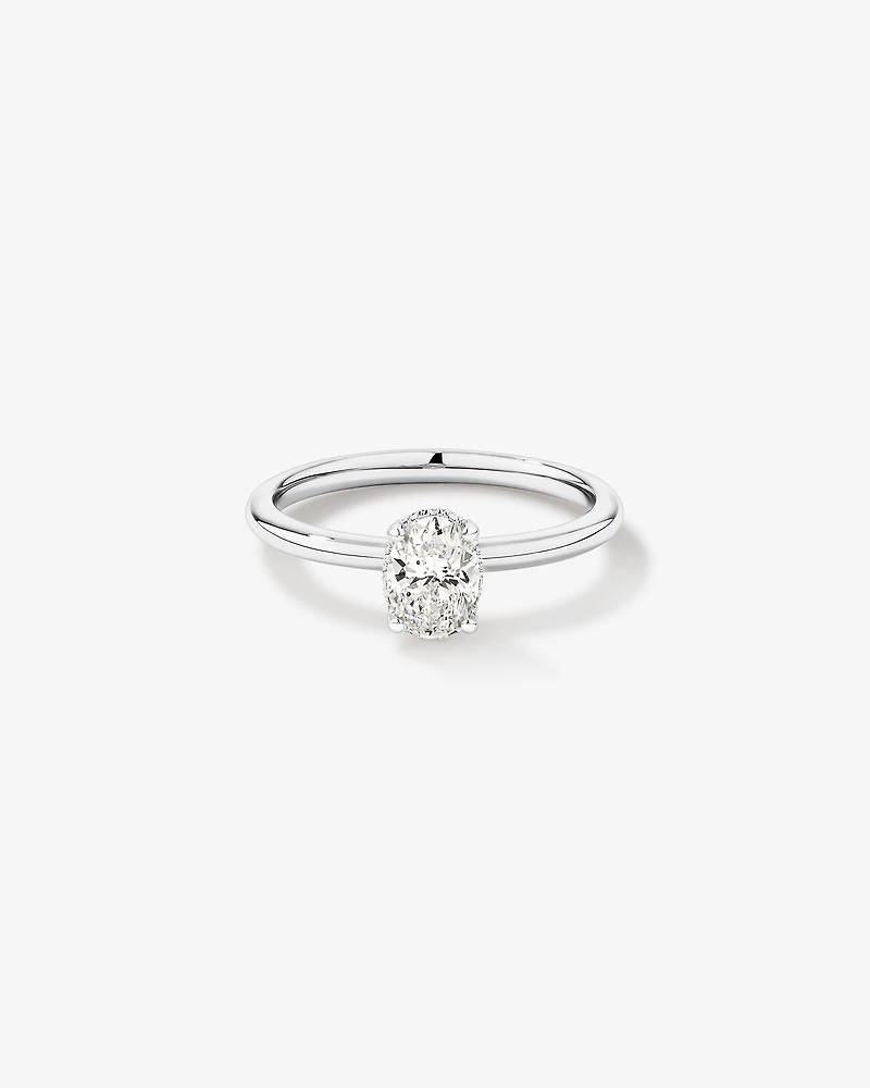 0.68 Carat TW Oval Cut Diamond Solitaire Hidden Pave Halo Engagement Ring in Platinum