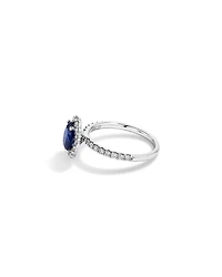 Oval Cut Blue Sapphire Gemstone and 0.60 Carat TW Diamond Halo Ring in 14kt White Gold