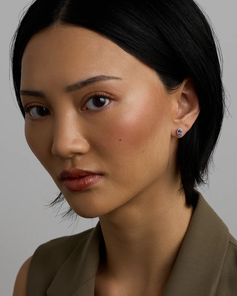 Oval Cut Blue Tanzanite Gemstone and 0.12 Carat TW Diamond Halo Stud Earrings in 10kt White Gold