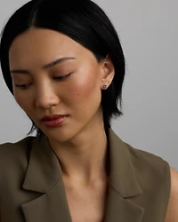 Oval Cut Blue Tanzanite Gemstone and 0.12 Carat TW Diamond Halo Stud Earrings in 10kt White Gold