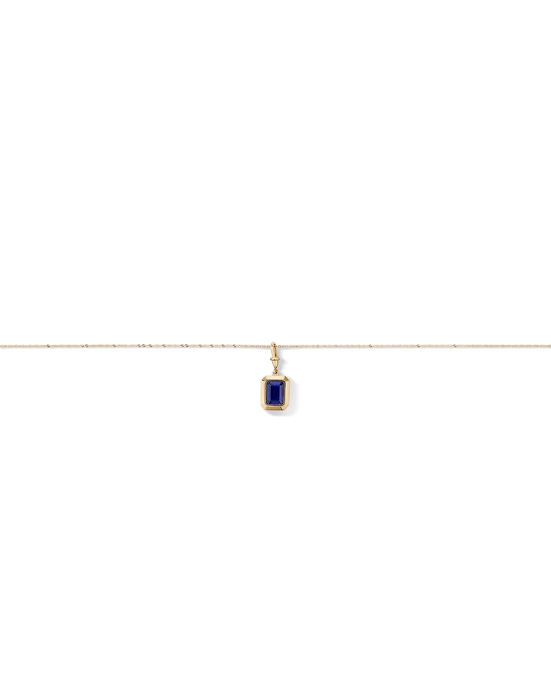 Emerald Cut Created Sapphire Bezel Pendant with Chain in 10kt Yellow Gold