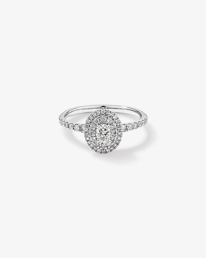 0.58 Carat TW Oval Diamond Halo Baguette Side Accent Engagement Ring in 14kt White Gold