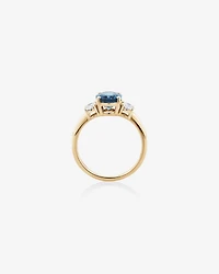 Bague en or jaune 14 K avec topaze bleue et diamants totalisant 0,46 ct