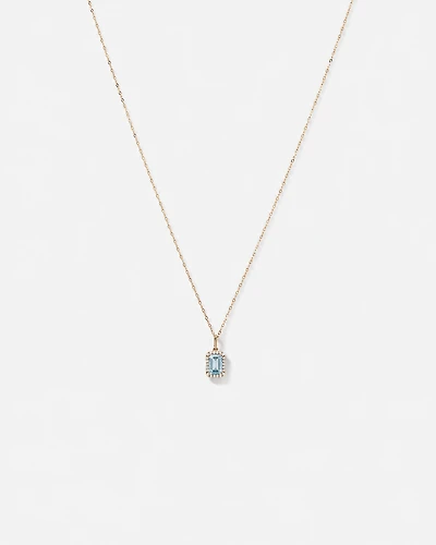 Pendentif halo Topaze bleue taille émeraude avec diamants et chaîne en or jaune 10 ct