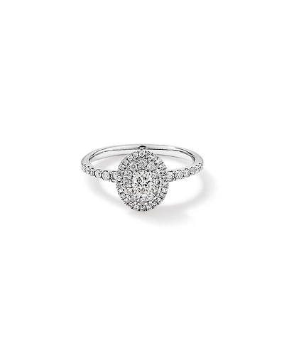 0,58 carat TW bague de fiançailles halo avec diamant ovale et accents latéraux baguette en or blanc 14 carats