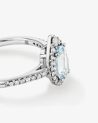 Oval Cut Blue Aquamarine Gemstone and 0.29 Carat TW Diamond Halo Ring in 10kt White Gold