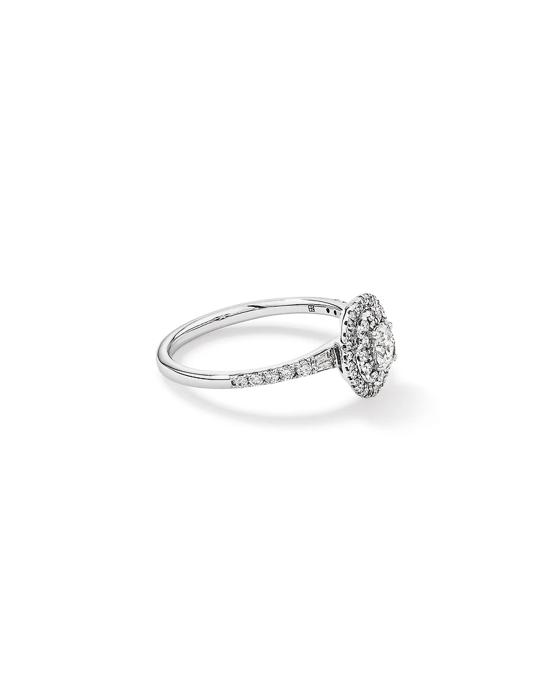 0.58 Carat TW Oval Diamond Halo Baguette Side Accent Engagement Ring in 14kt White Gold