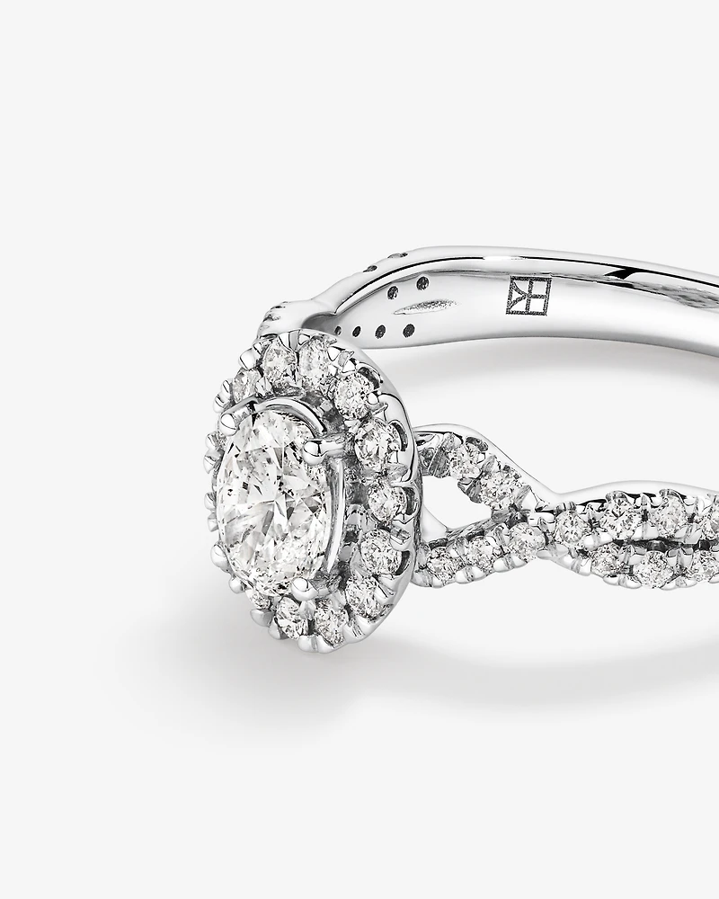 0.75 Carat TW Oval Cut Diamond Twist Side Accent Halo Engagement Ring in 14kt White Gold