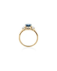 Bague en or jaune 14 K avec topaze bleue et diamants totalisant 0,46 ct