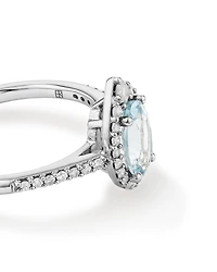 Oval Cut Blue Aquamarine Gemstone and 0.29 Carat TW Diamond Halo Ring in 10kt White Gold