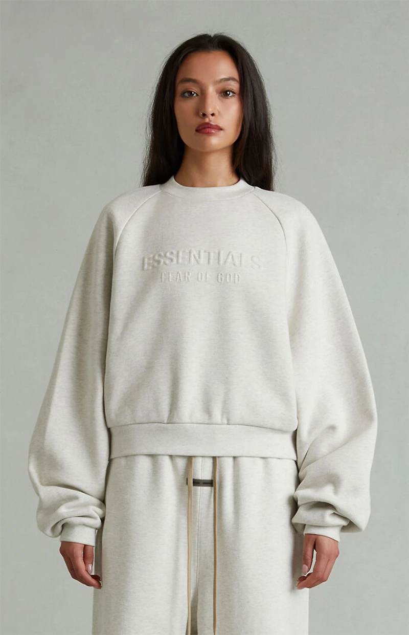 Fear of God ESSENTIALS Women's Heather Oatmeal '90s Embossed Raglan Cropped Crew Neck Sweatshirt