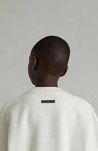 Fear of God ESSENTIALS Kids Heather Oatmeal Embossed Classic Crew Neck Sweatshirt