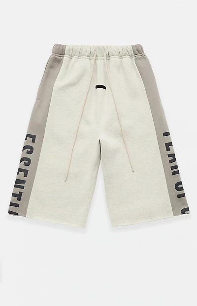 Fear of God ESSENTIALS Vanilla Paneled Raw Cutoff Sweat Shorts