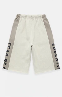 Fear of God ESSENTIALS Vanilla Paneled Raw Cutoff Sweat Shorts