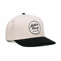 Comus Two Toned Trucker Hat in White and Black