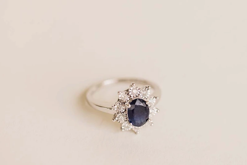 Oval Halo Ring with Blue Sapphire and .18 Carat TW of Diamonds in 10kt White Gold