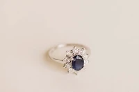 Oval Halo Ring with Blue Sapphire and .18 Carat TW of Diamonds in 10kt White Gold