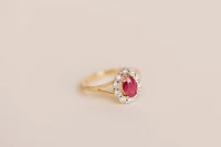 Oval Halo Ring with Ruby and .12 Carat TW of Diamonds in 10kt Yellow Gold