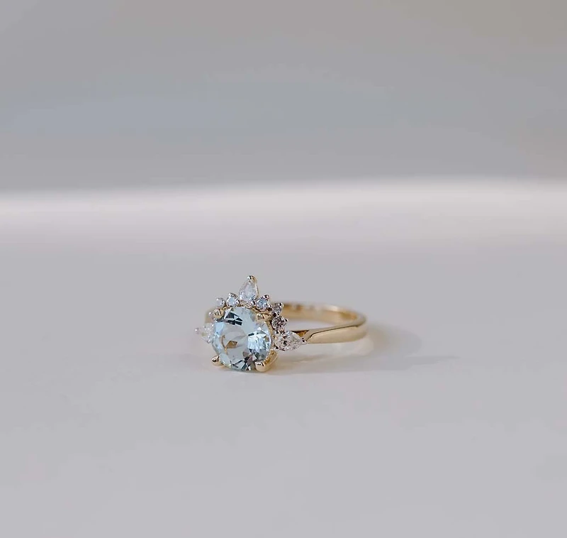 Ring with 7MM Round Aquamarine and .25 Carat TW of Diamonds in 14kt Yellow Gold