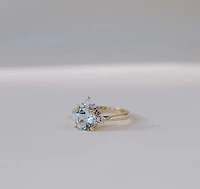 Ring with 7MM Round Aquamarine and .25 Carat TW of Diamonds in 14kt Yellow Gold